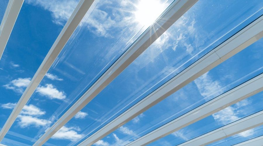 Clear multiwall polycarbonate roofing panels on a pergola showing light transmission through the sheet channels